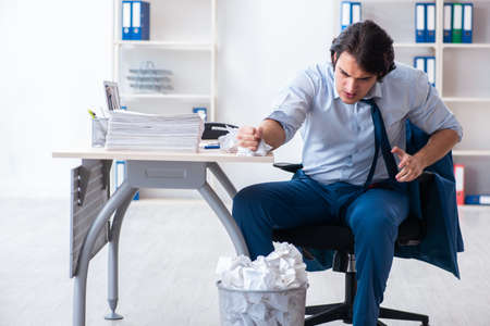 Businessman rejecting new ideas with lots of papersの写真素材