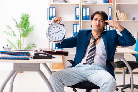Employee coming to work straight from bedの写真素材