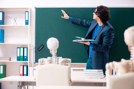 Male teacher and skeleton student in the classroomの写真素材