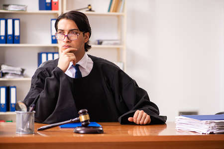 Young handsome judge working in courtの写真素材