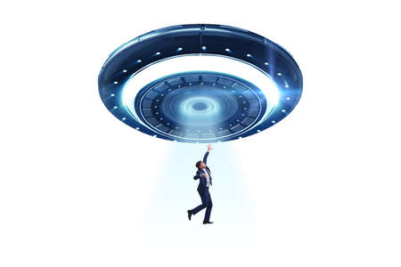 Flying saucer abducting young businessmanの写真素材