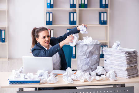 Businesswoman rejecting new ideas with lots of papersの写真素材