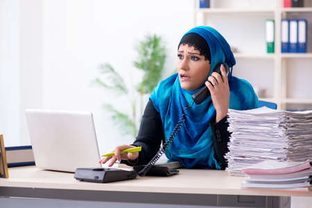 Female employee in hijab working in the officeの写真素材