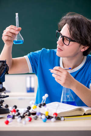 Young male student in the classroomの写真素材