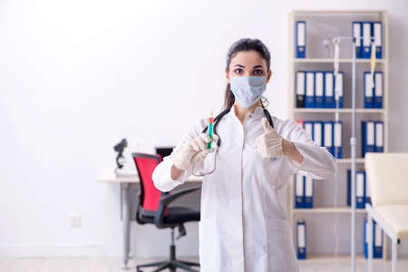 Young female doctor in infusion conceptの写真素材