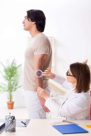 Female doctor checking patients joint flexibility with goniometerの写真素材