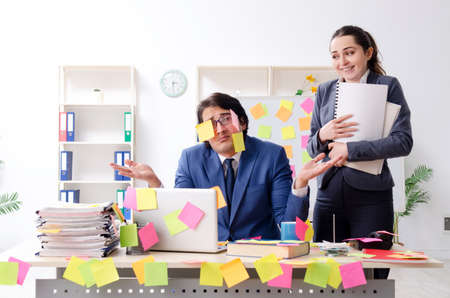 Two colleagues employees working in the officeの写真素材