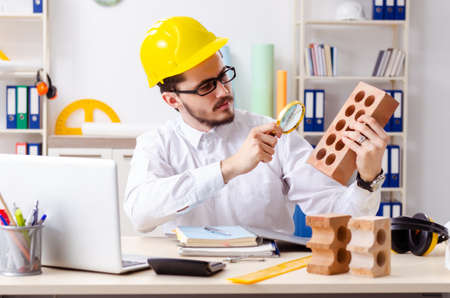 Young male architect working in the office