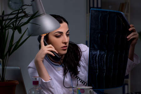 Young female doctor working at night shiftの写真素材