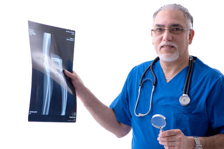 White bearded old doctor radiologist working in clinic