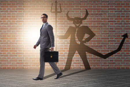 Devil hiding in the businessman - alter ego conceptの写真素材