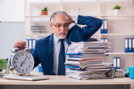Aged male employee working in the officeの写真素材