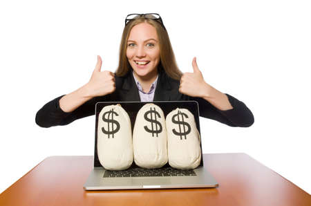 Female employee with money sacks on her tableの写真素材