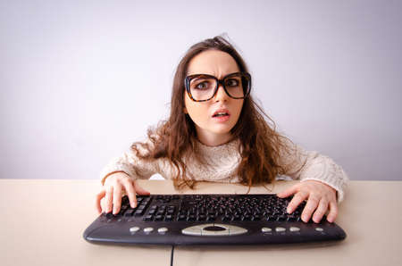Funny nerd girl working on computer