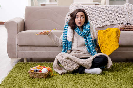 Young beautiful woman knitting at home