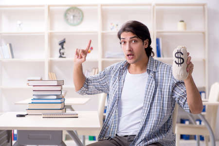 Young male student preparing for exams at homeの写真素材