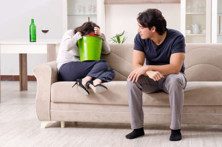 Young wife suffering from sick stomach and vomitingの写真素材