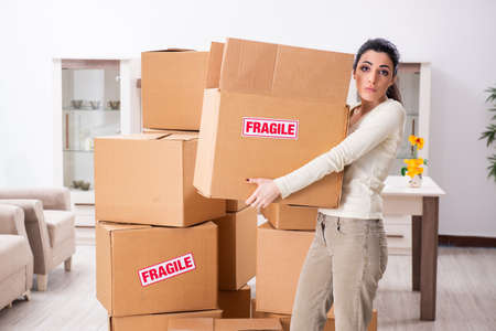 Young woman moving to new flat