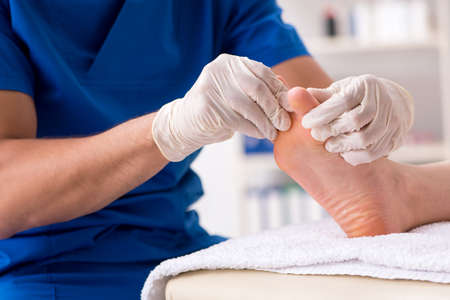 Podiatrist treating feet during procedureの写真素材