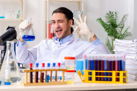 Young male chemist working in the lab
