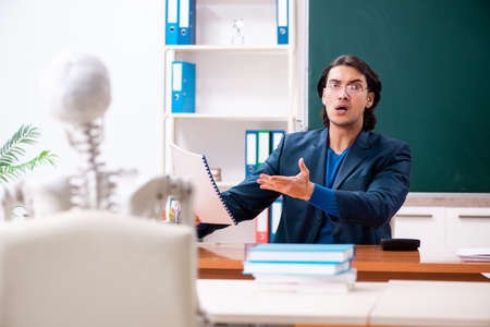 Male teacher and skeleton student in the classroomの写真素材