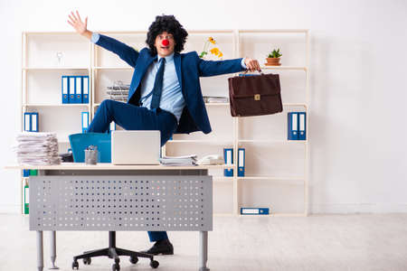 Young clown businessman working in the officeの写真素材