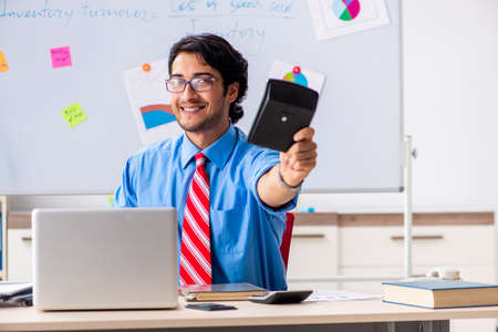 Young male financial manager working in the officeの写真素材