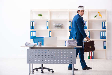 Head injured male employee working in the officeの写真素材