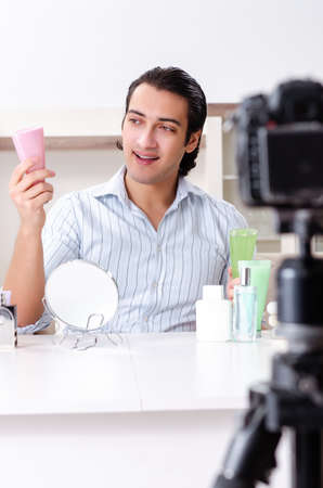 Young handsome man recording his blog in hygiene conceptの写真素材