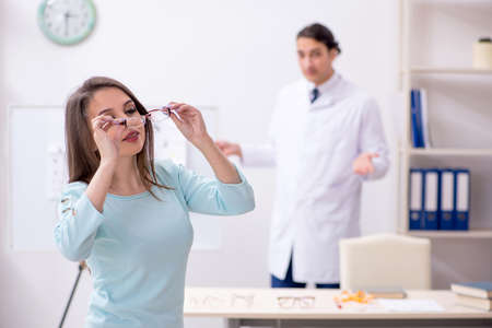 Young woman visiting male doctor oculist