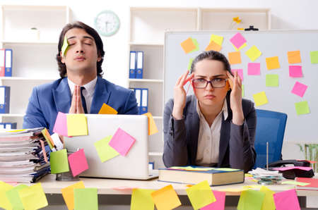 Two colleagues employees working in the officeの写真素材