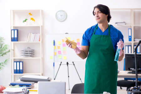 Male handsome professional cleaner working in the officeの写真素材