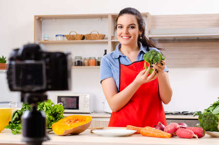 Young female vegetarian recording video for her blogの写真素材