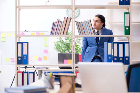 Young handsome employee in the officeの写真素材