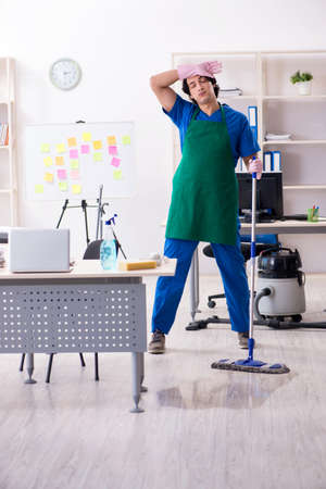 Male handsome professional cleaner working in the officeの写真素材