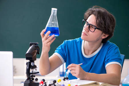 Young male student in the classroomの写真素材