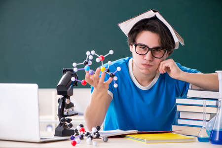 Young male student in the classroomの写真素材