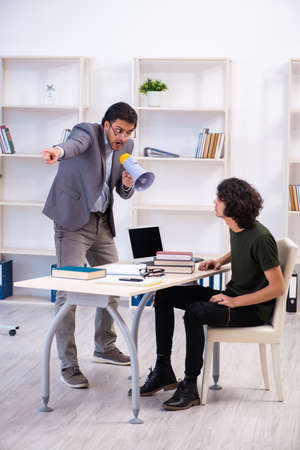 Young teacher and student in the classroomの写真素材