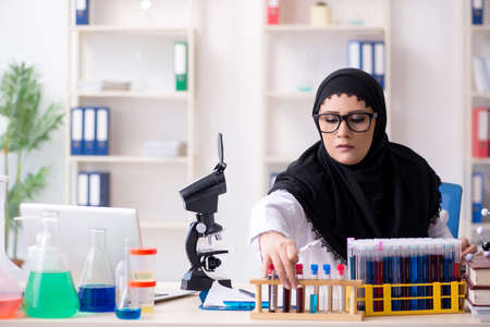 Female chemist in hijab working in the lab