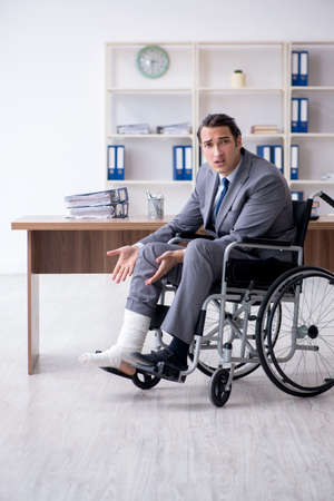 Male employee in wheel-chair in the officeの写真素材