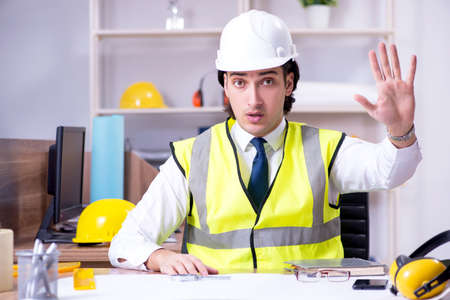 Young male architect working in the office
