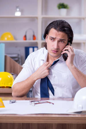 Young male architect working in the officeの写真素材