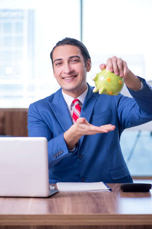 Young handsome businessman sitting in the officeの写真素材