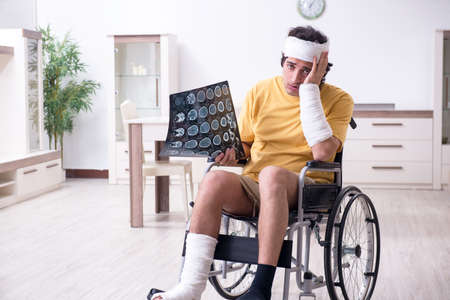 Young man after accident recovering at homeの写真素材