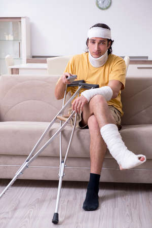 Young man after accident recovering at homeの写真素材