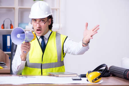 Young male architect working in the officeの写真素材