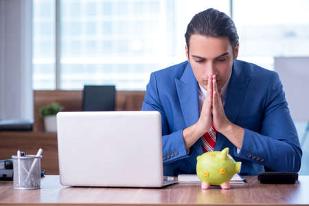 Young handsome businessman sitting in the officeの写真素材