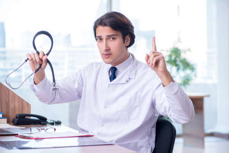 Young handsome doctor working in the clinicの写真素材