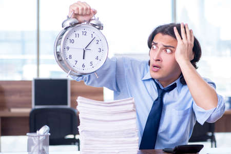 Young employee unhappy with excessive workの写真素材