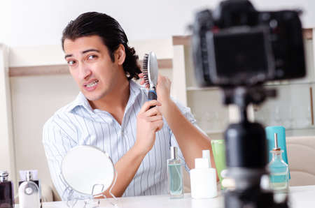 Young handsome man recording his blog in hygiene conceptの写真素材